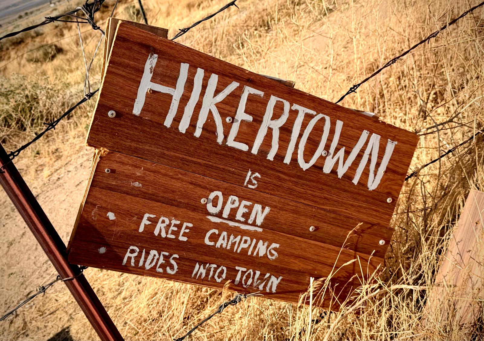 The Hikertown motel front under a burning dusk sky